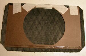 Cloth glued and taped in place along top edge